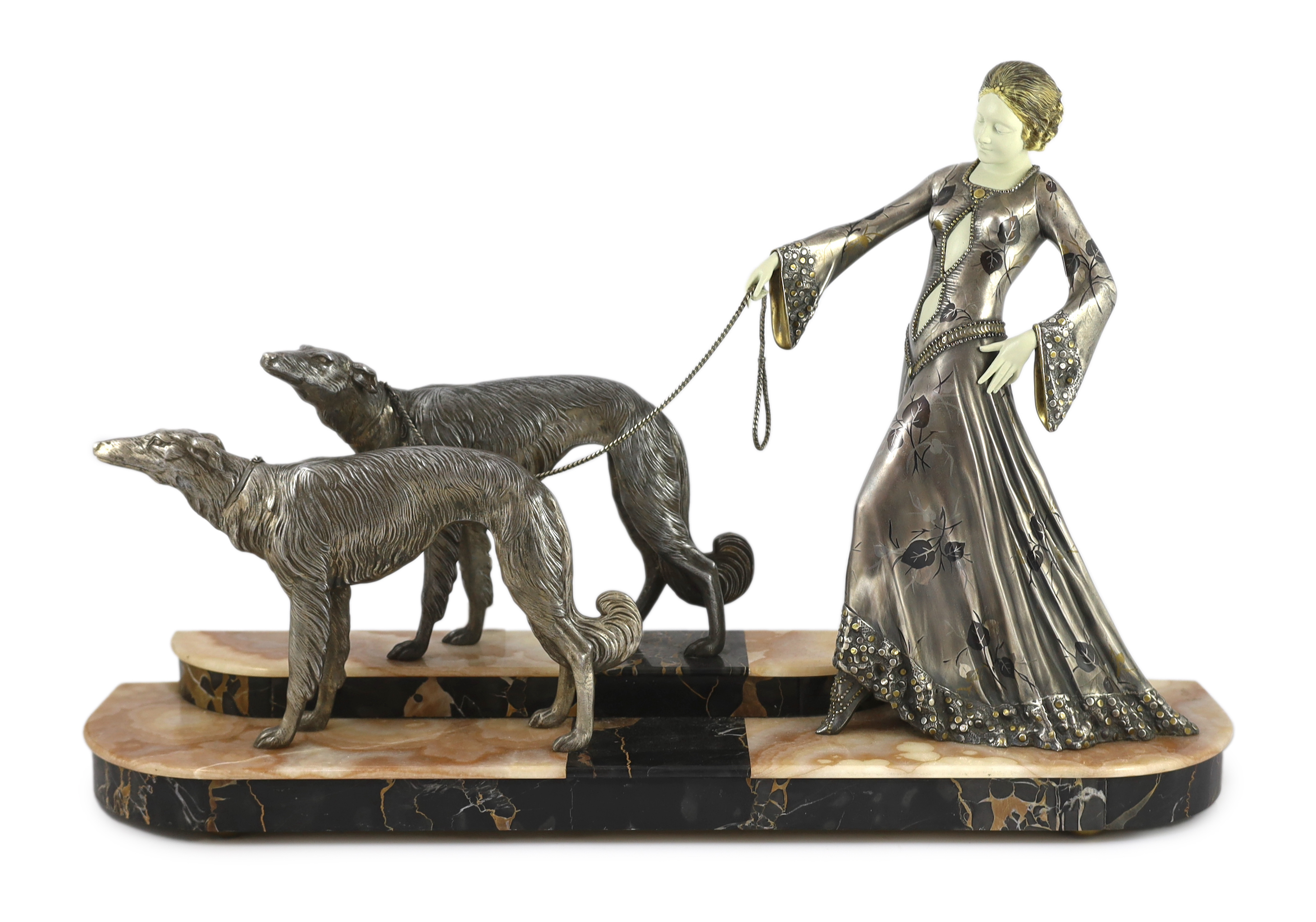 Georges Gori (French, 1894-1944). An Art Deco silvered bronze, spelter and composition group of an elegant lady and two borzoi, 80cm wide, 20cm deep, 51cm high